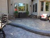 Tiered Stamped Concrete Patios with Rock Face Step